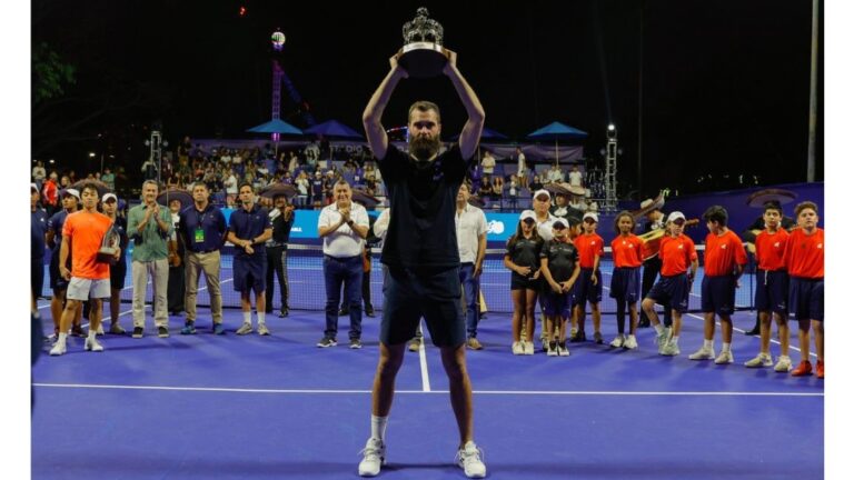 Benoit champion of PuertVallarta Open holding his trophy