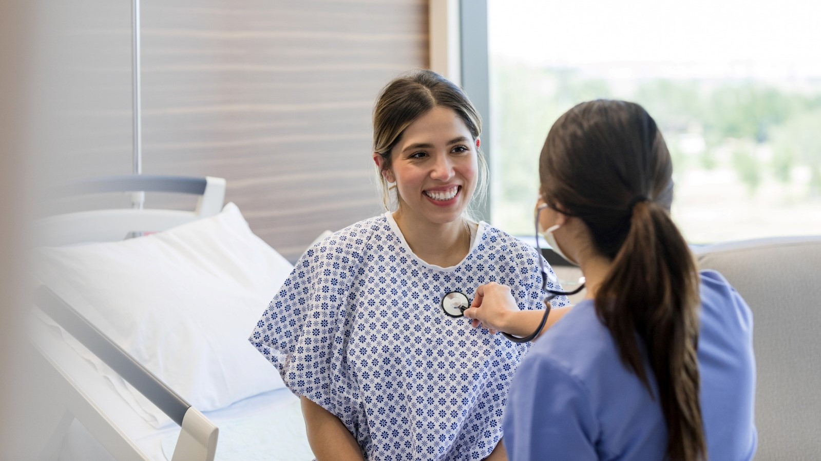 Health worker checking a female patient