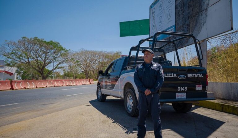 Policeman standing by his patrol truck