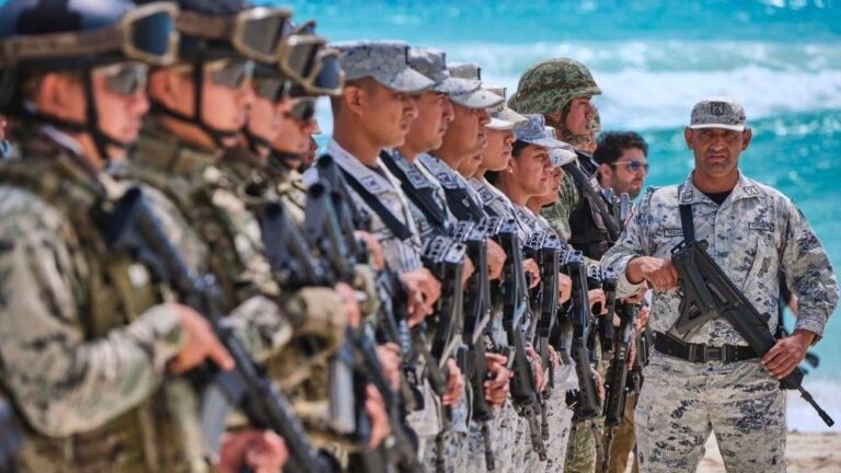 Security elements standing on a beach in Cancun