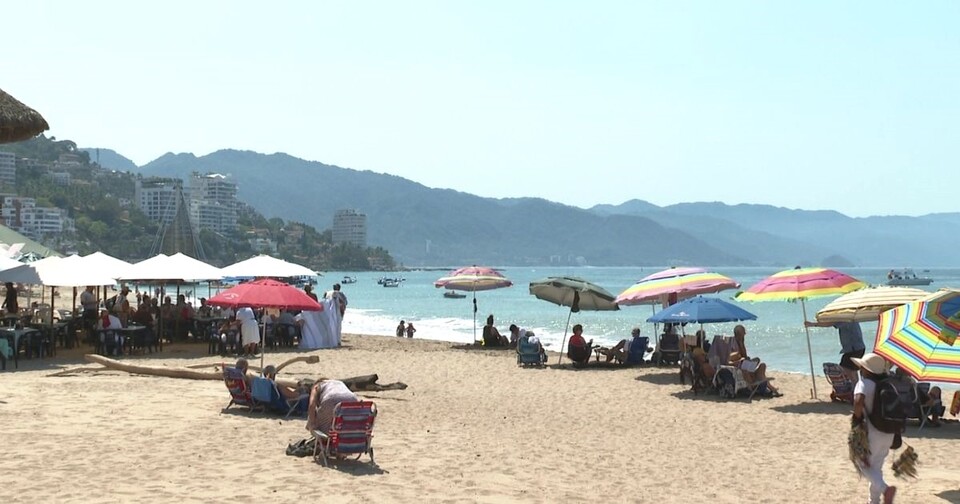 Pueto Vallarta beach withumbrellas and vendors