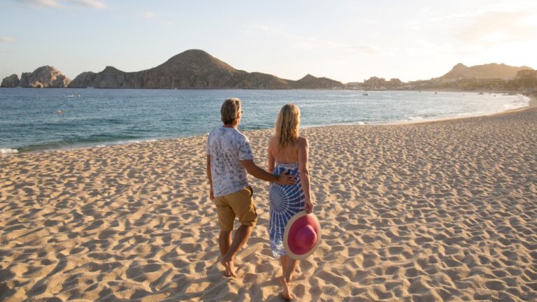 Couple walking on the beach in Los Cabos in Spring