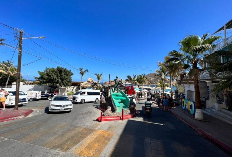 Cars driving by El Medano beach access