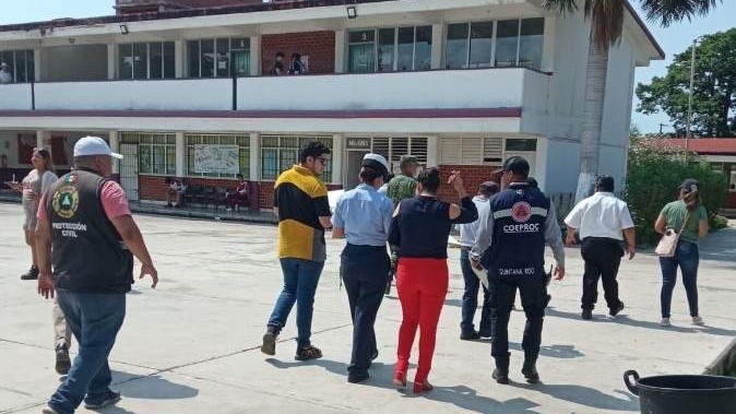 Authorities walking by buildings in Cancun