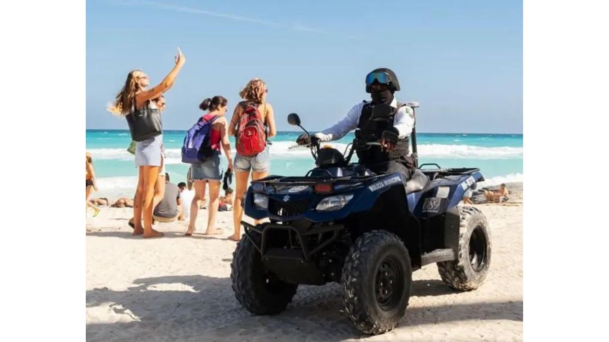 policeman patrolling the beach on an ATV