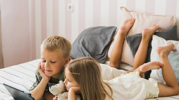 children looking at an electronic device