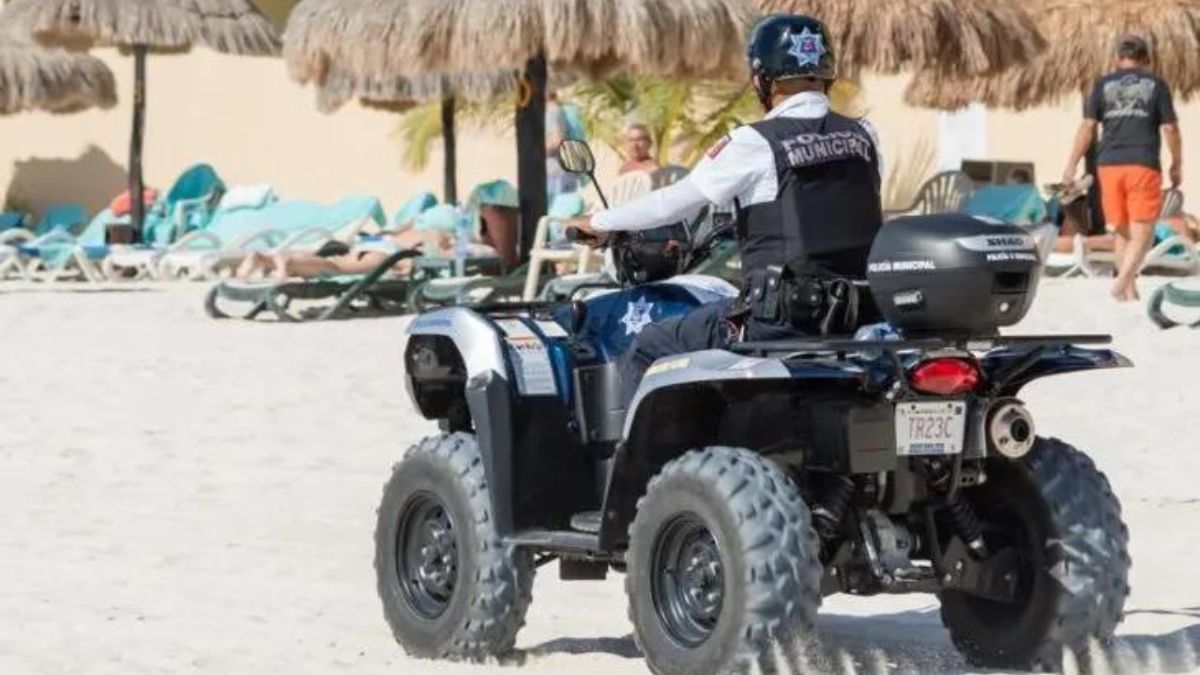 Policeman on an atv on the beach