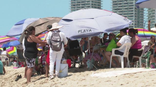 Beach vendors renting umbrellas on Puerto Vallarta beaches