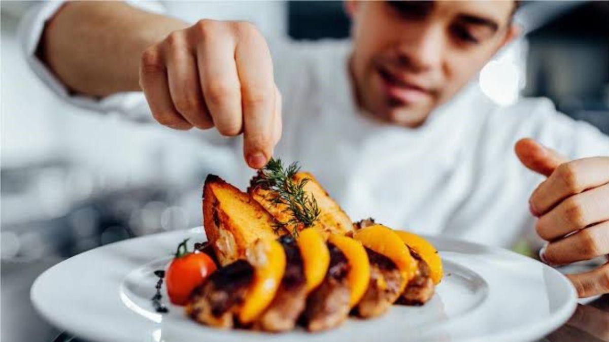 Top chef touching up a dish