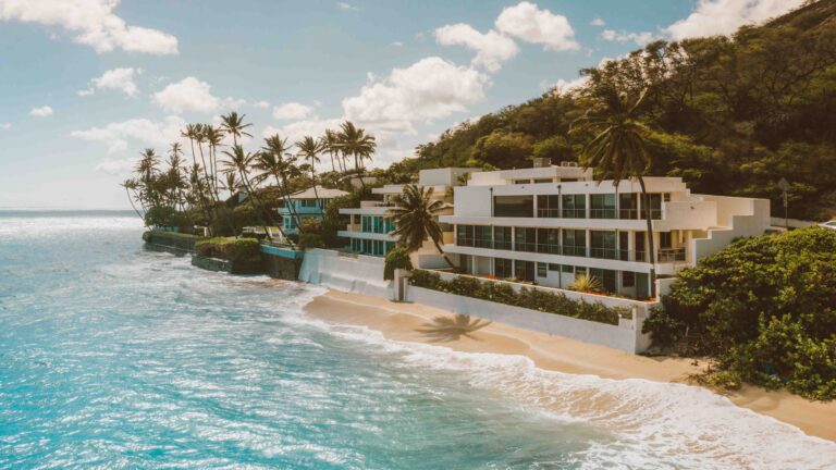 Luxury modern house on a beach in Mexico, symbolizing the thriving real estate market and the allure of investment opportunities.