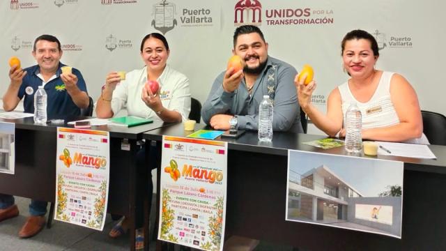 People announcing Mango Festival with mangoes in their hands.