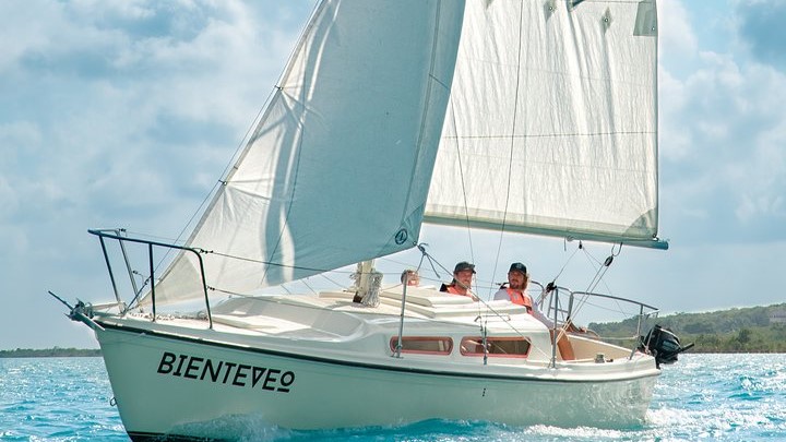 Couple taking sun on a sailboat