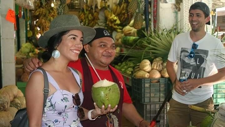 Woman drinking from a coconut in Puerto Morelos food tour