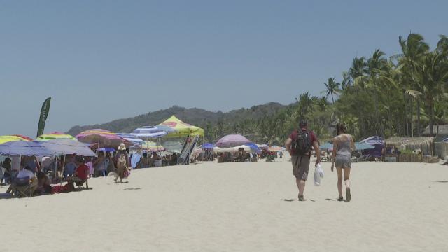 tourists walking on the beach