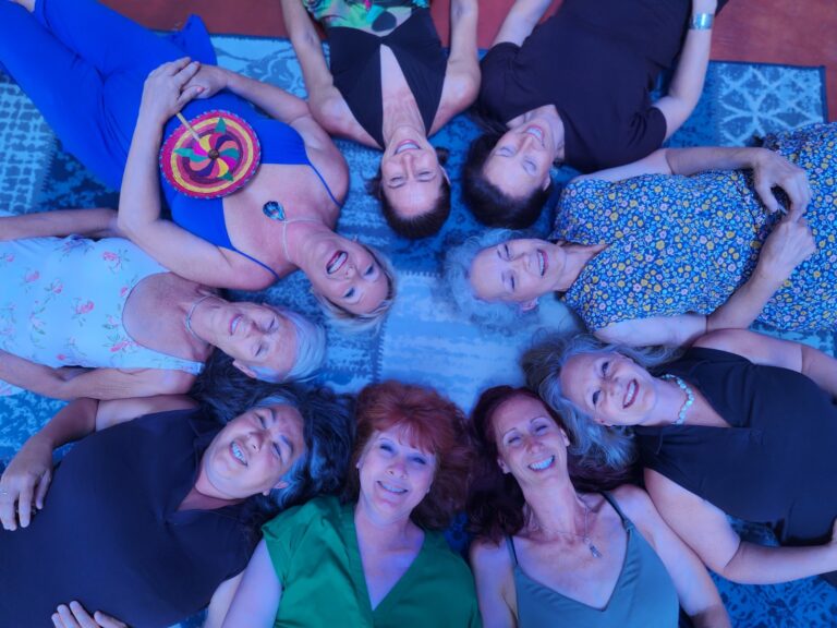 Photo of women writing lying on the floor