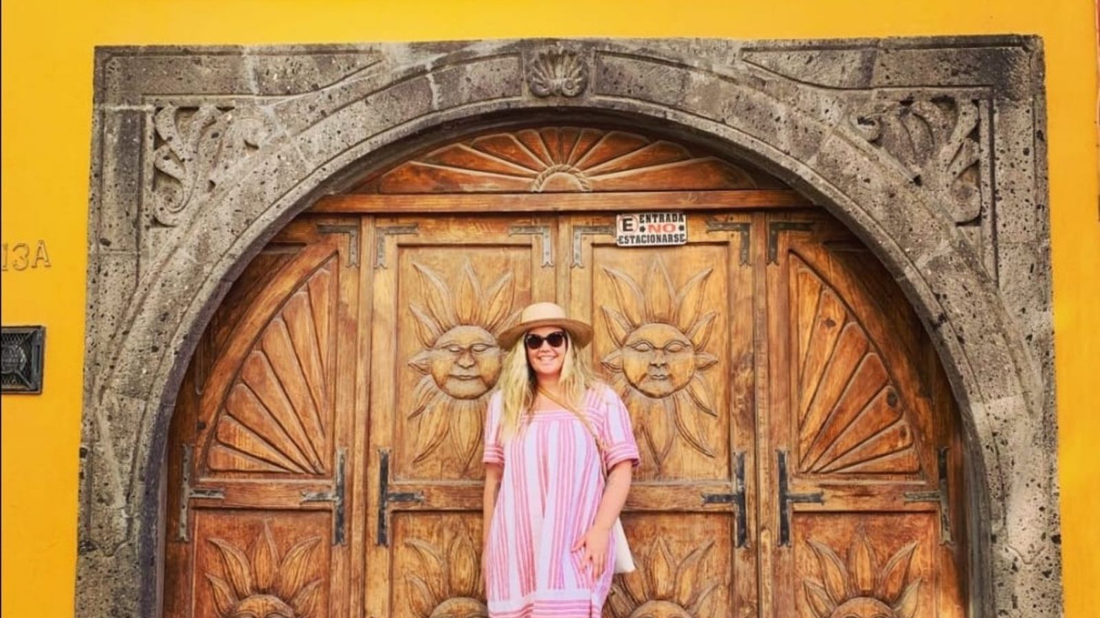 Woman standing in front of a wooden door