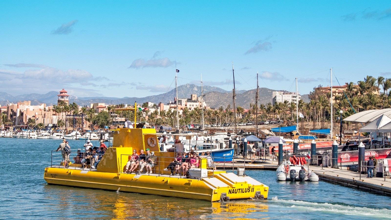 Yellow boat departing in Los Cabos marina