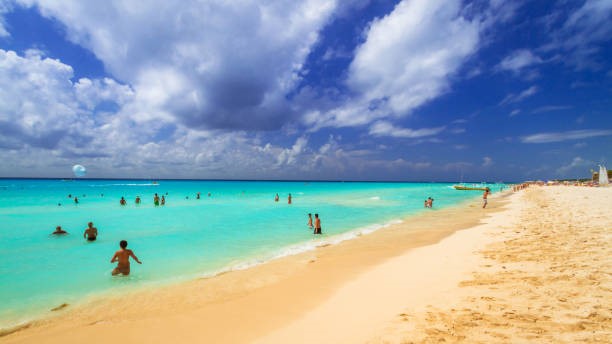 Beach in Cancun with swimmers