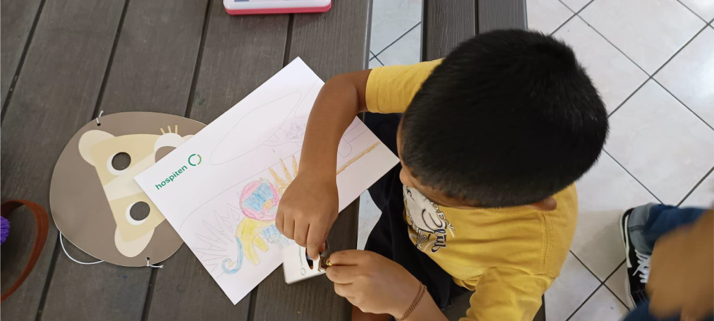 RISE child painting during a Hospiten visit