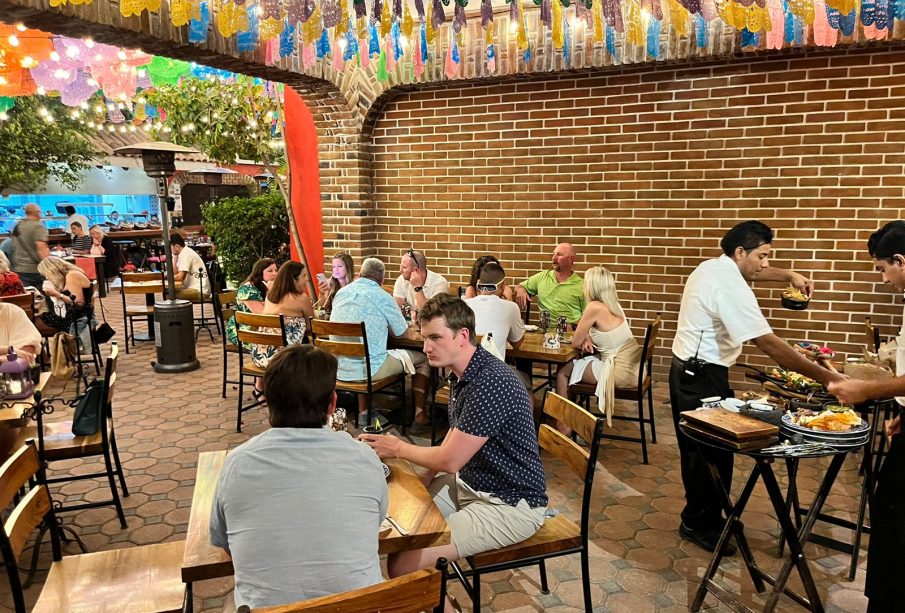 People sitting at tables in a restaurant, with vibrant decorations enhancing the ambiance