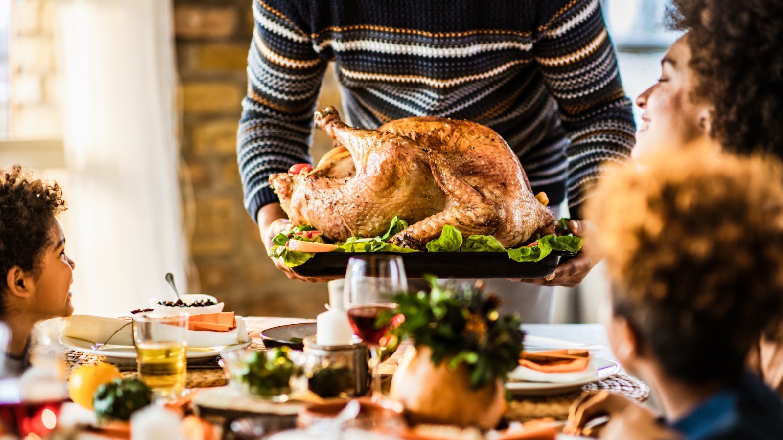 A man serving Thanksgiving dinner for his family