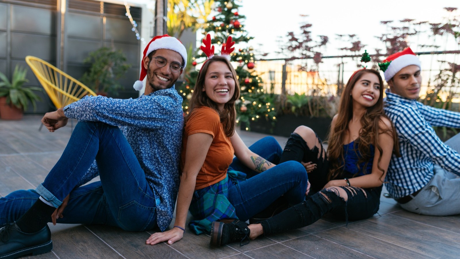 Young people sitting with Christmas hats on