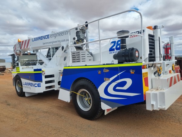 A TIDD PC28-2 Crane, in white and blue, viewed from the left rear side branded to the Lawrence Engineering Colours
