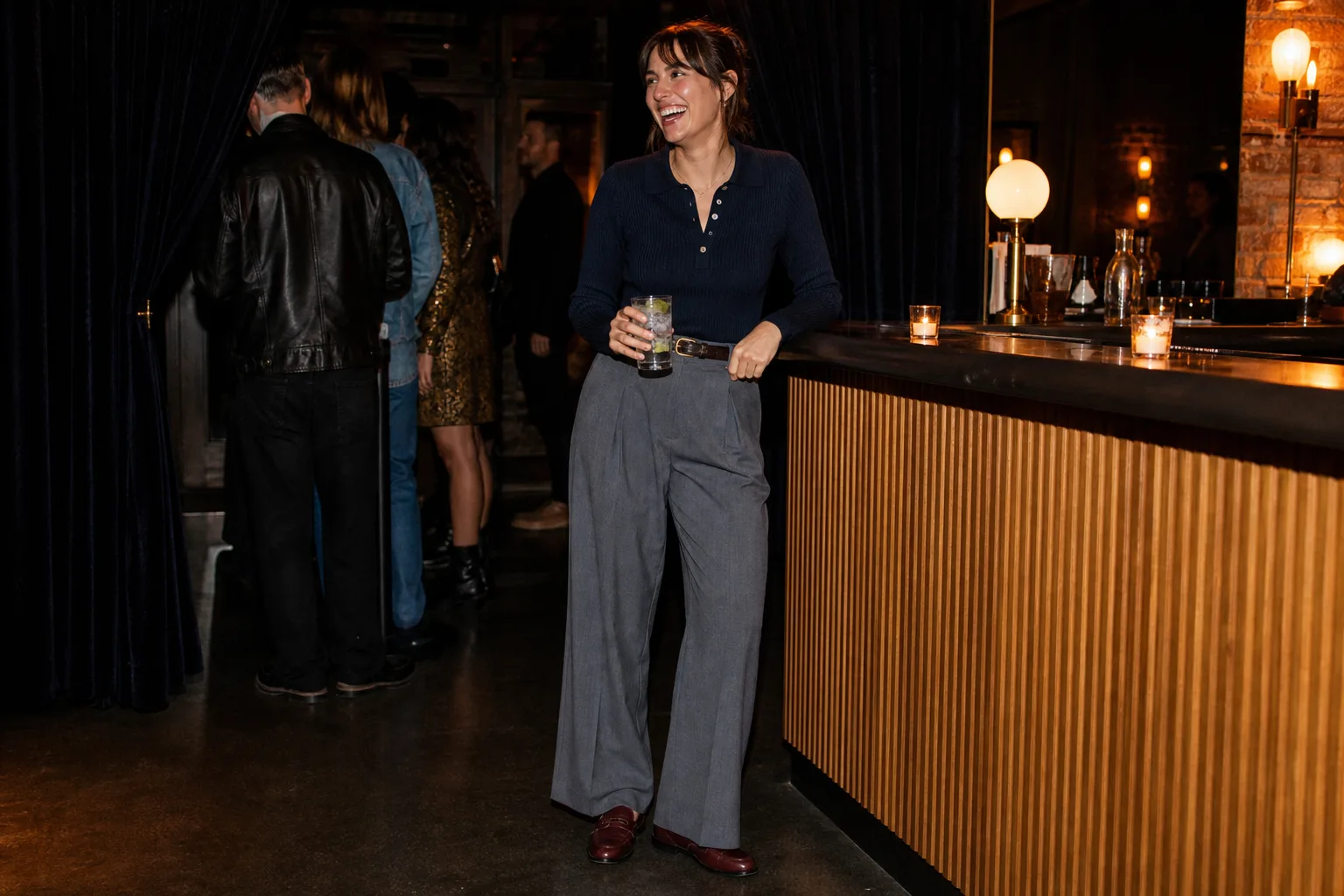 Navy knit polo with gray wide-leg trousers and burgundy loafers