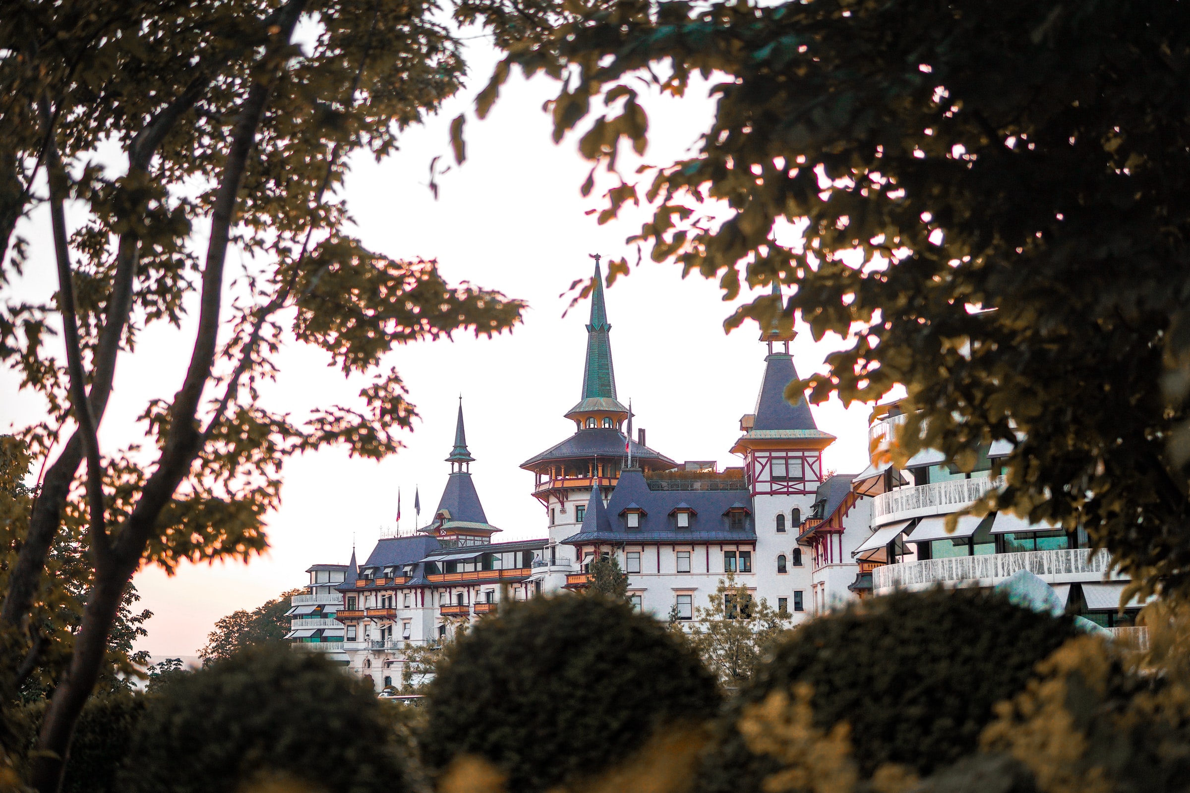 Towers of the exclusive Dolder Grand Spa seen through trees