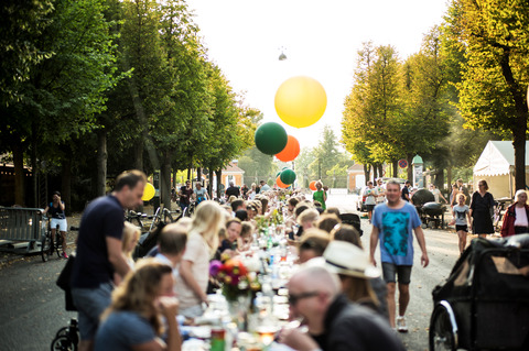 Street fest in Copenhagen with long tables full of people and food