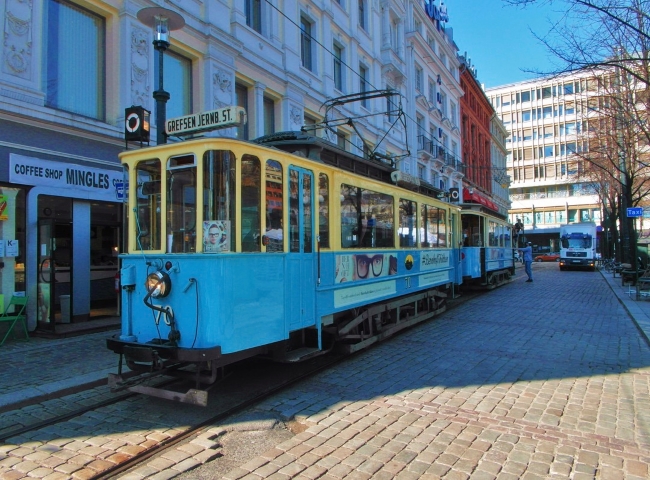 Blue and yellow Old City Tram on historic Oslo street