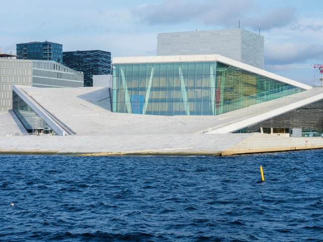 View of Oslo Opera with deep blue water in foreground