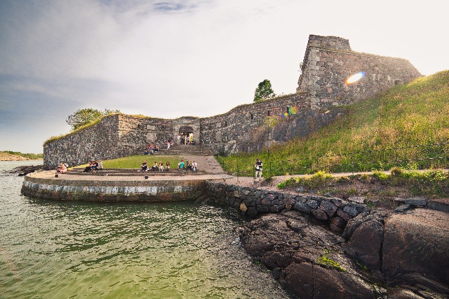 Historic stony Suomenlinna Sea Fortress seen from curving walkway