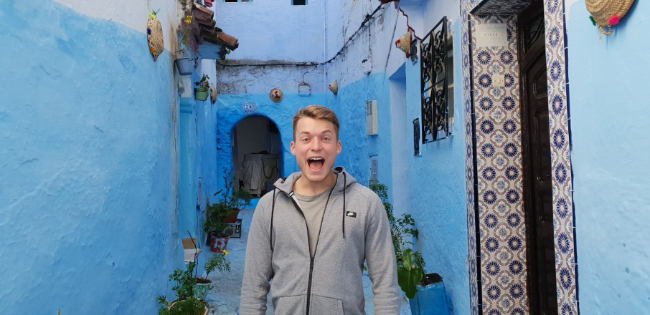 Kevin screaming in a blue alleyway with moroccan tile