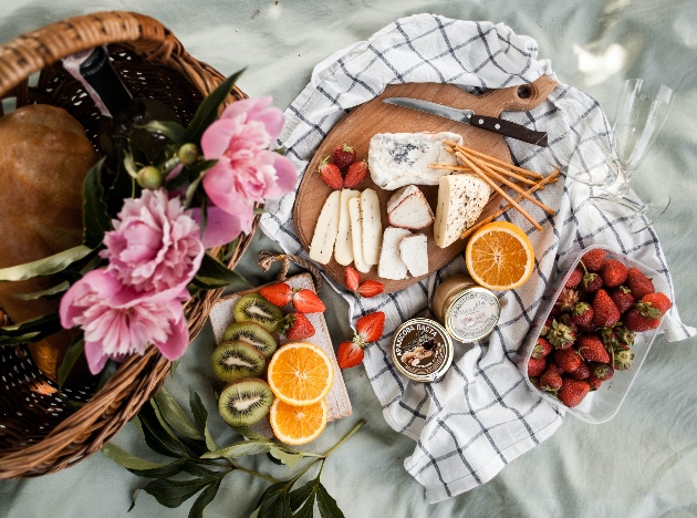 Picnic blanket in Paris park spread with cheese and wine