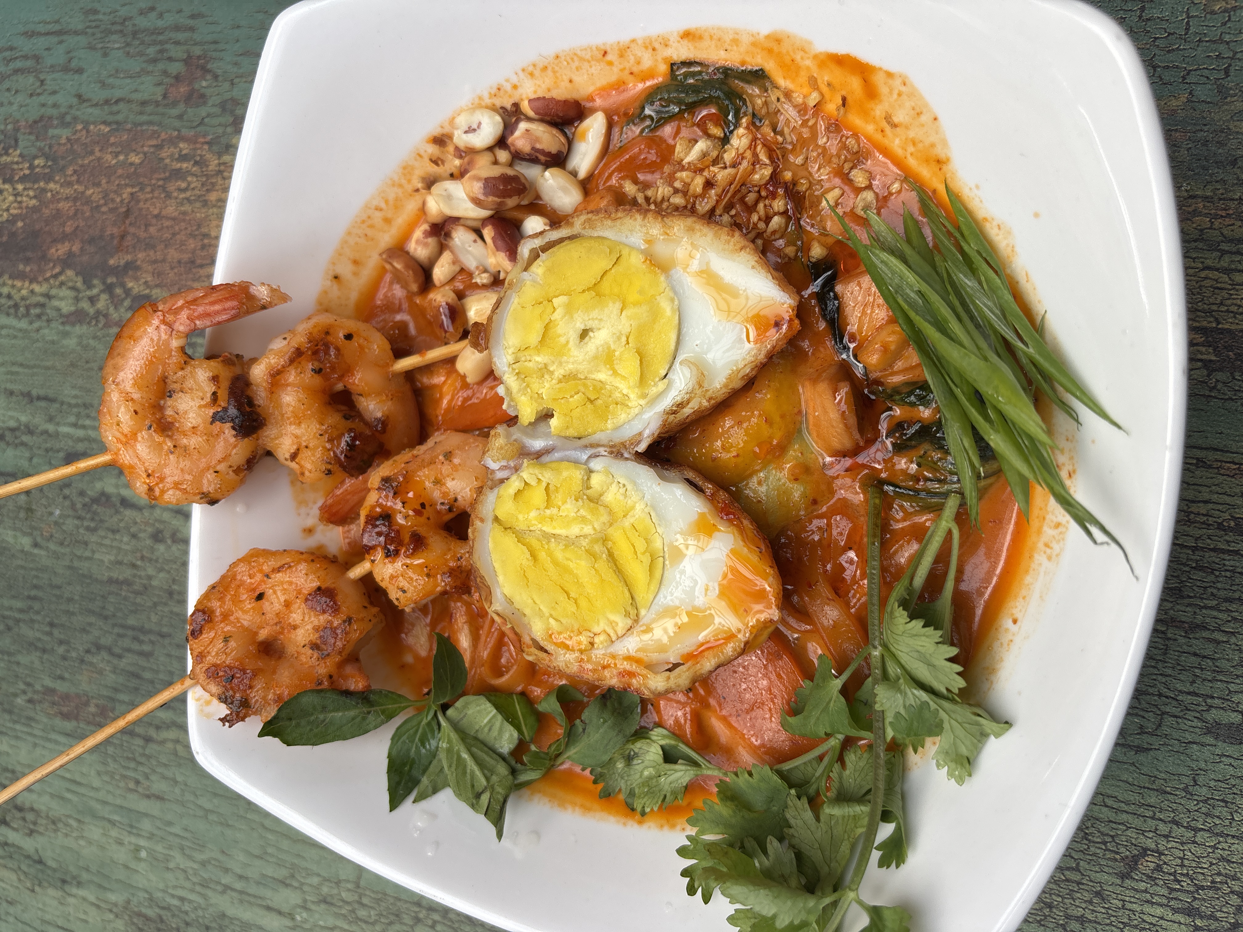 Thai noodle bowl served with grilled prawn & egg