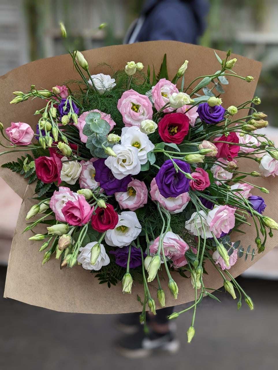 A large hand-tied bouquet of assorted lisianthus.