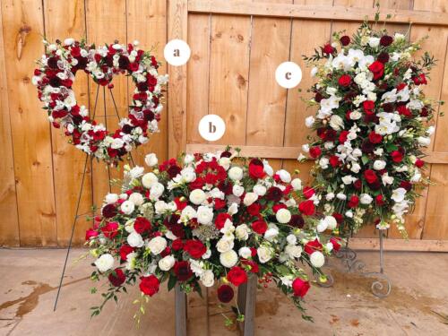 A matching red and white easel spray, casket spray, and heart for a bereavement.