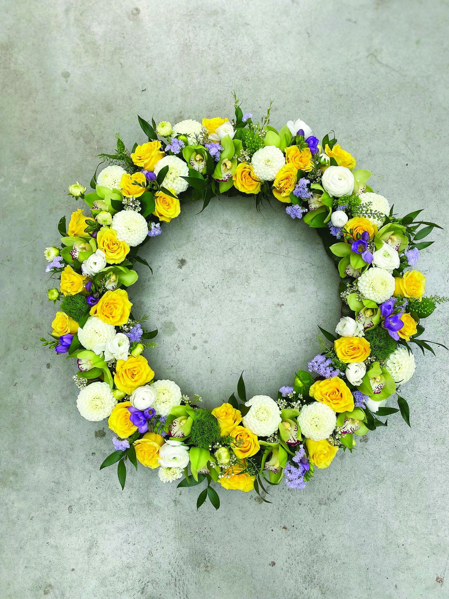 A large yellow, white, and purple floral wreath.