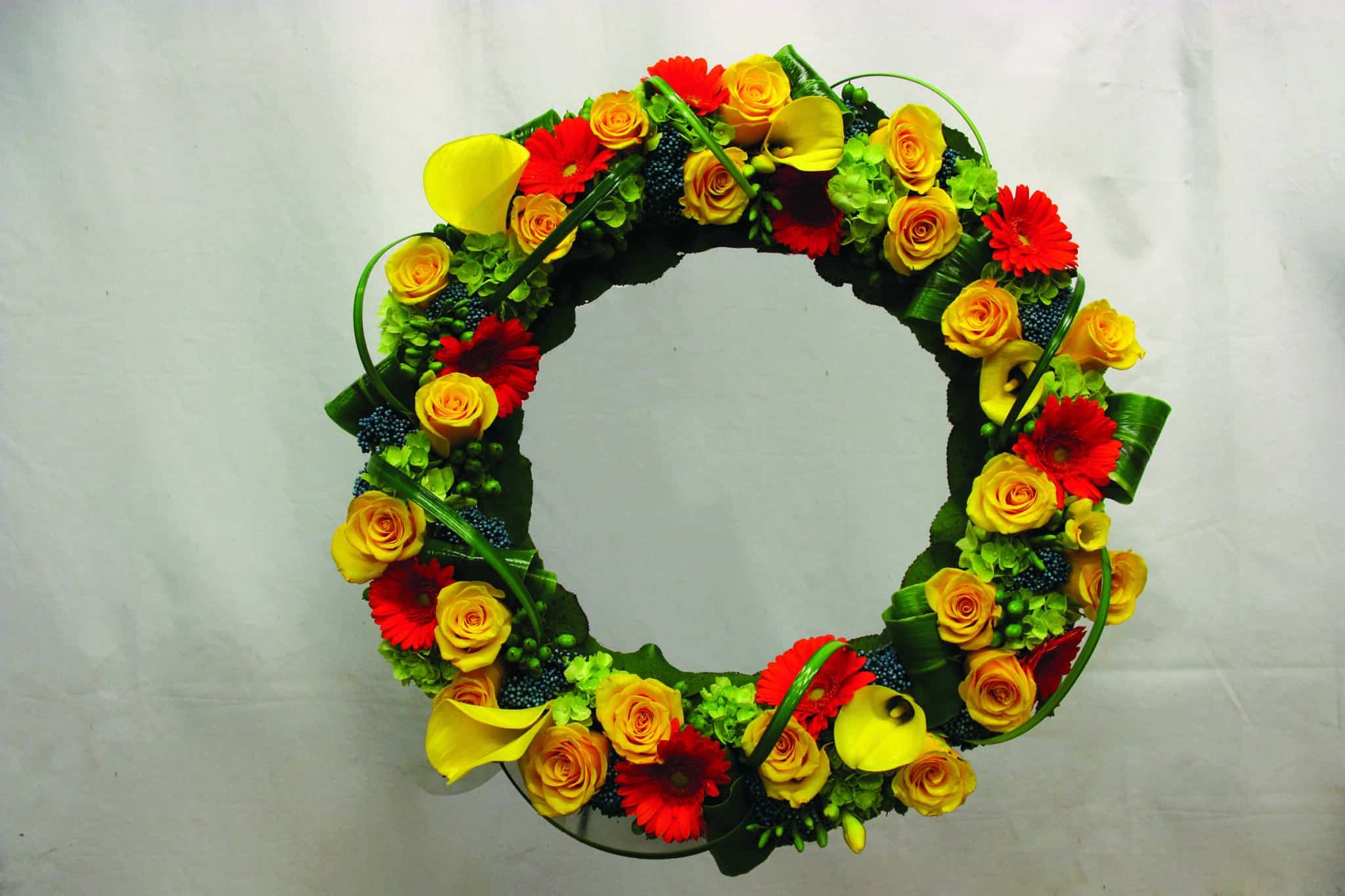 An orange and yellow bereavement wreath.