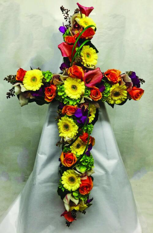 A colourful red, yellow, and orange floral cross.