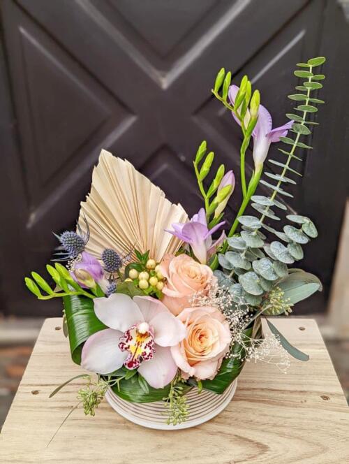 A pastel coloured European style arrangement with fresh and dried flowers.