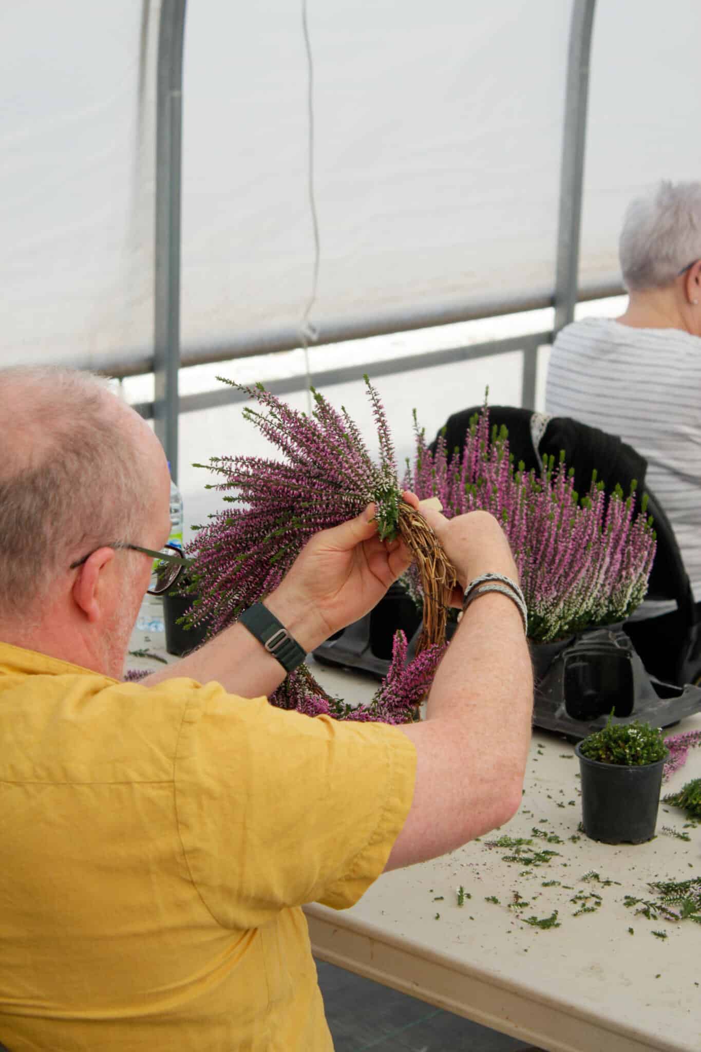 Workshop Guest Assembling a Heather Wreath Workshop guest assembling a heather wreath at The Watering Can Flower Market workshop