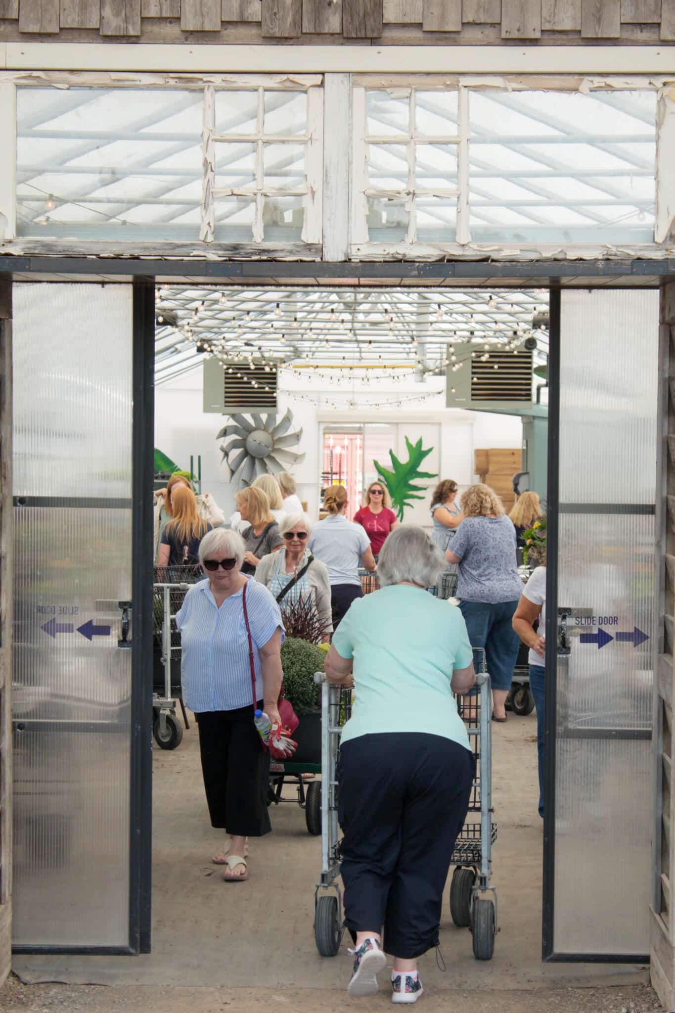 Customers Entering the Watering Can Greenhouse Customers walking into the greenhouse entrance at The Watering Can Flower Market in Vineland