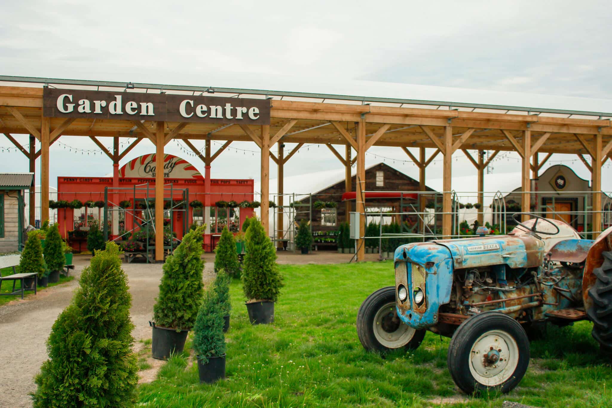 Exterior view of The Watering Can Garden Centre in Vineland with the iconic blue tractor on display.