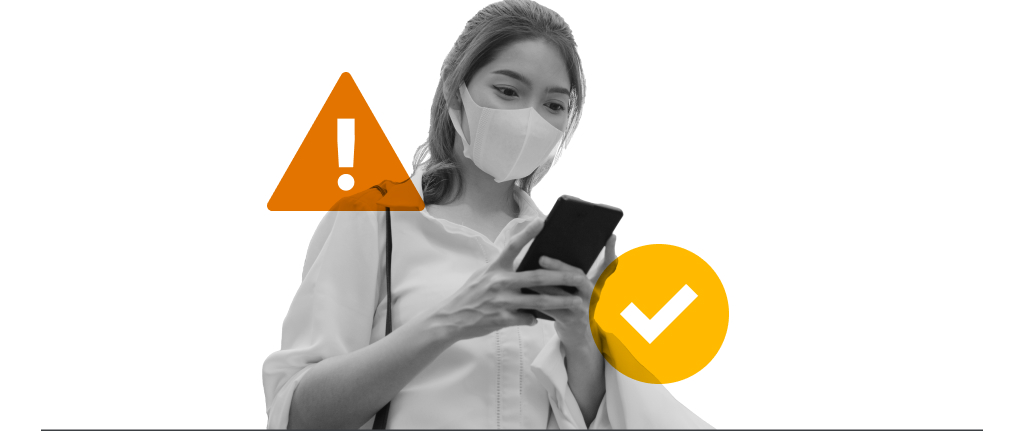 A caution sign and a tick overlaying a woman using her mobile phone as she fact-check claims and scrutinize brands to ensure they are authentic, trustworthy, sustainable and ethical