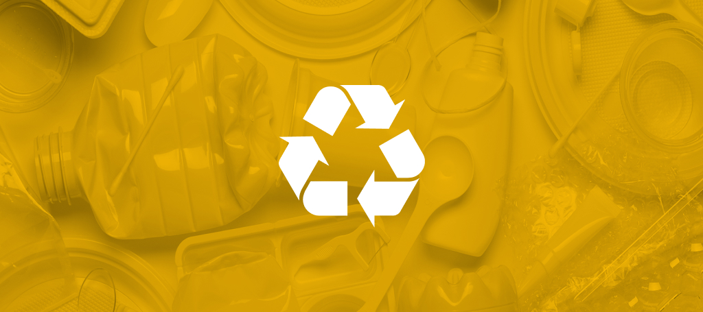 A recycling icon overlaying crushed disposable plastic products