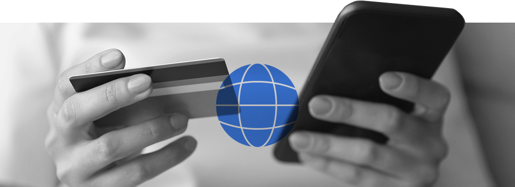 A person holding a mobile phone in one hand and a bank card in the other to conduct a financial transaction online