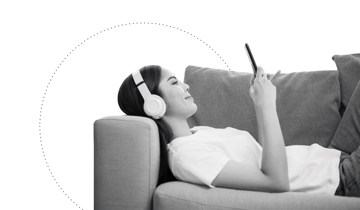 A woman with headphones lies on a sofa using her phone to engage with good content on YouTube, as travel, food, fitness, music and beauty icons circle her, emphasizing the importance of content-driven marketing and video engagement.