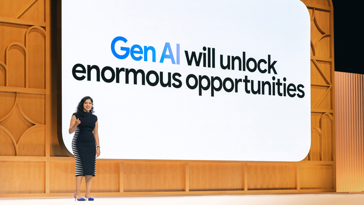 Vidhya Srinivasan, Google’s VP and general manager of Ads, speaks in front of a large screen reading “Gen AI will unlock enormous opportunities” on stage at Google Marketing Live, May 21, 2024.